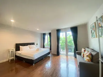 a bedroom with a bed and a couch at 3 Bedroom Spacious Home in Downtown Bangkok Near MRT BTS Asok Station in Bangkok