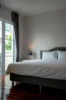 a bedroom with a large bed and a window at 3 Bedroom Spacious Home in Downtown Bangkok Near MRT BTS Asok Station in Bangkok