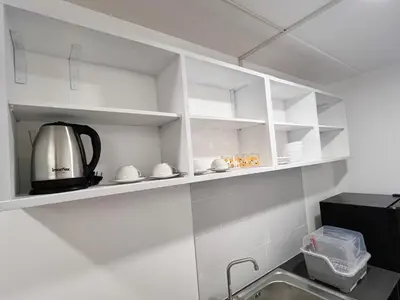 a kitchen with white cabinets and a kitchen sink at Impact - Donmueng Popular C4 in Ban Song Hong