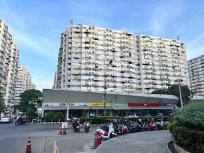a large building with motorcycles parked in a parking lot at Impact - Donmueng Popular C4 in Ban Song Hong