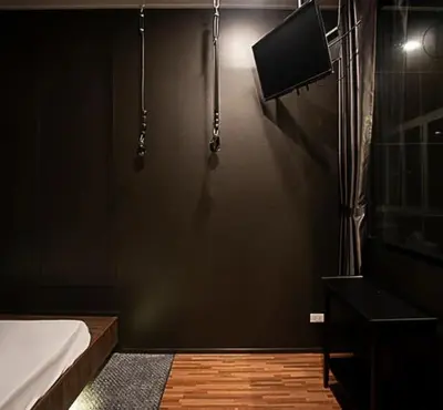 a bathroom with a shower and a television on the wall at NY Resort Nonthaburi in Nonthaburi