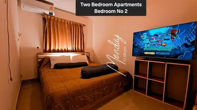 a bedroom with a bed and a flat screen tv at River View 8 in Yan Nawa