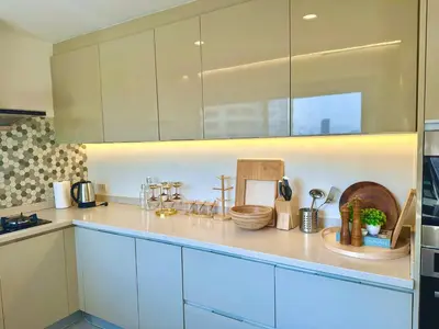 a kitchen with white cabinets and a counter top at Luxury 3 bedrooms in the heart of the city in Bangkok