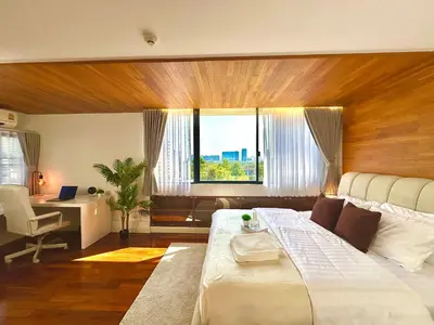 a bedroom with a bed and a desk and a window at Luxury 3 bedrooms in the heart of the city in Bangkok