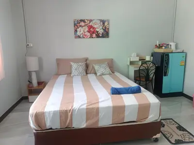 a bedroom with a large bed in a room at The little home in Bangkok