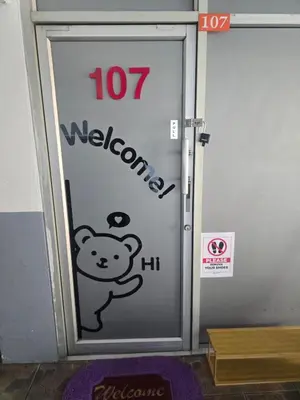 a door with a sticker of a teddy bear on it at Beautiful Studio 107 Apartment with nice living room with WiFi in Bangkok
