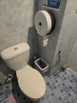 a bathroom with a toilet and a roll of toilet paper at Beautiful Studio 107 Apartment with nice living room with WiFi in Bangkok