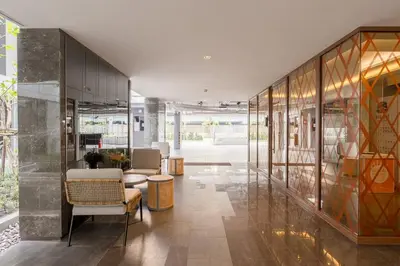 a lobby of a building with glass walls at 1BR Apt - Pool, Gym, Rooftop, BTS, Coworking Space - 10 min Nana Plaza - Central - New Building - 24 7 Security in Bangkok