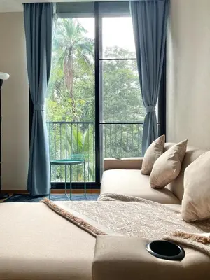 a bedroom with a bed and a large window at Phrom Phong Top 1BD pool,gym,park and mall BTS in Khlong Toei