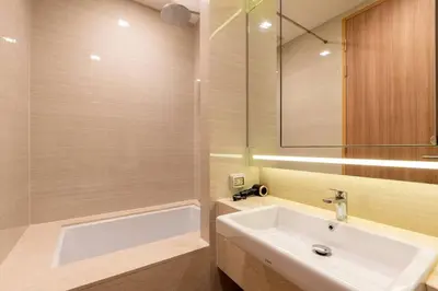 a bathroom with a white sink and a mirror at Phrom Phong Top 1BD pool,gym,park and mall BTS in Khlong Toei