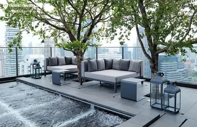 a patio with couches and a tree on a building at Phrom Phong Top 1BD pool,gym,park and mall BTS in Khlong Toei