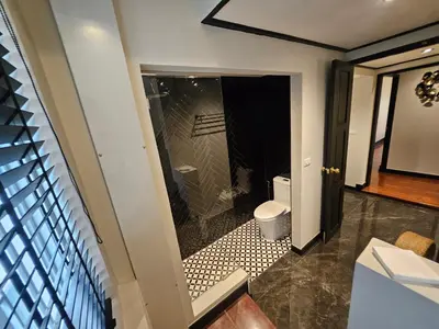 a bathroom with a toilet and a glass shower at Soho Heritage House China Town Bangkok in Bangkok