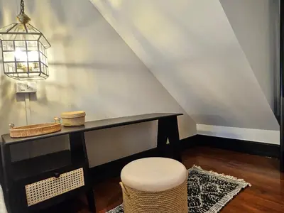 a dining room with a table and a stool at Soho Heritage House China Town Bangkok in Bangkok