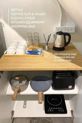 a kitchen shelf with a coffee pot and towels at BaanBaan - Cozy home 5pax, 5min BTS, Boat, old town explore in Bangkok