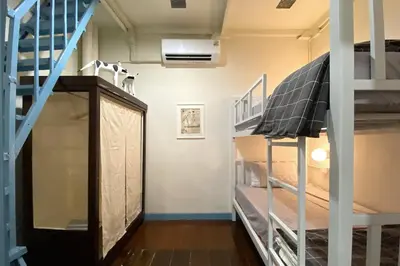 a room with bunk beds and a staircase at BaanBaan - Cozy home 5pax, 5min BTS, Boat, old town explore in Bangkok