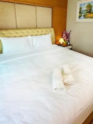 a large white bed with two towels on it at convenient&peaceful place in Soi nai leot in Bangkok