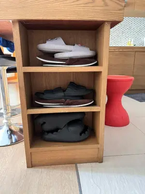 a wooden shelf with plates and shoes on it at convenient&peaceful place in Soi nai leot in Bangkok