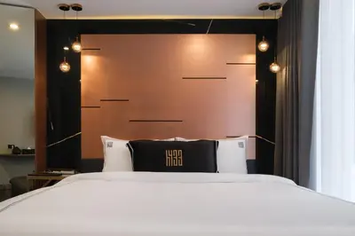 a bedroom with a large white bed with lights above it at Hotel 433 - Asoke Sukhumvit in Bangkok
