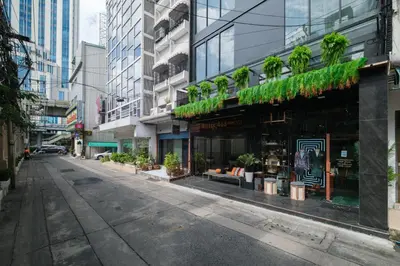 an empty street in a city with tall buildings at Hotel 433 - Asoke Sukhumvit in Bangkok