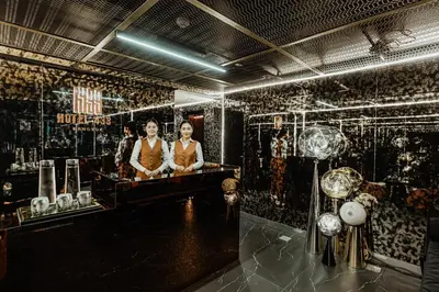 two women are standing in a room with a tub at Hotel 433 - Asoke Sukhumvit in Bangkok