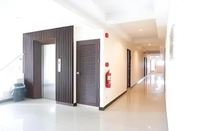 a hallway of a hospital with two doors at Collection O VResotel in Nonthaburi