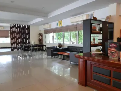 a living room with a couch and a table at Collection O VResotel in Nonthaburi