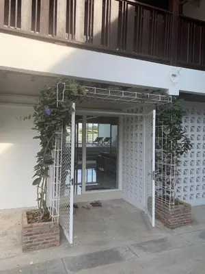 an open entrance to a building with two plants at Canal Villa on Onnut Road, near Bts Onnut, Bangkok in Amphoe Phra Khanong