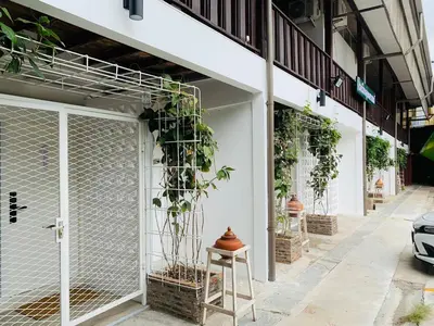 a building with plants on the side of it at Canal Villa on Onnut Road, near Bts Onnut, Bangkok in Amphoe Phra Khanong