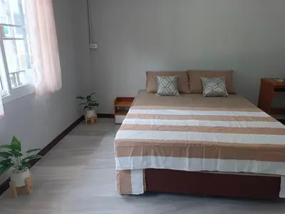 a bedroom with a large bed in a room at The Little home in Ban Khlong Mae Nam Bon