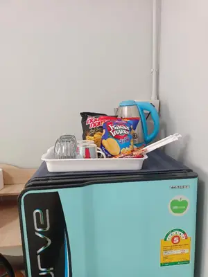a refrigerator with a plate of food on top of it at The Little home in Ban Khlong Mae Nam Bon