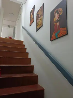 a set of stairs with paintings on the wall at The little home in Bang Mote