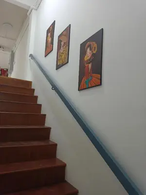 a stairway with paintings on the wall at The little home in Bang Mote