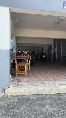 a garage with a table and motorcycles in it at PTts in Bangkok