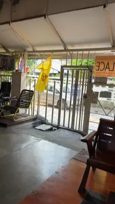 a room with chairs and a gate with a yellow umbrella at PTts in Bangkok