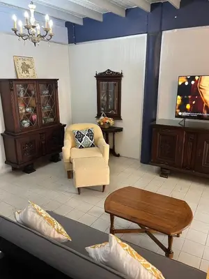 a living room with a couch and a table at Baan Saen Saran residence in Sathani Bang Ramat