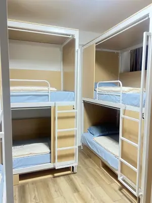 a room with three bunk beds in a room at JC home \u5218 \u5148 \u751f in Bangkok