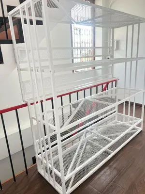 a white cage with a shelf in a room at JC home \u5218 \u5148 \u751f in Bangkok