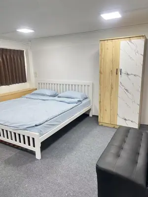a bedroom with a bed and a wooden door at JC home \u5218 \u5148 \u751f in Bangkok