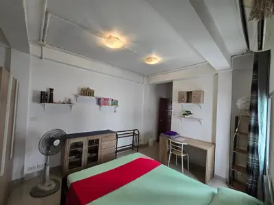 a small bedroom with a bed and a desk at Jatujak Bangkok guesthouse R3 in Sathani Bang Su