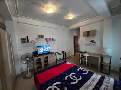 a bedroom with a bed and a desk and a television at Jatujak Bangkok guesthouse R3 in Sathani Bang Su