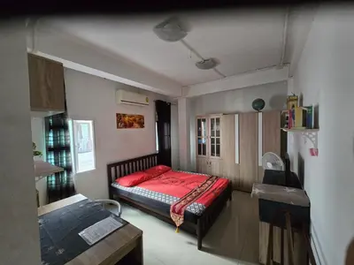 a bedroom with a red bed in a room at Jatujak Bangkok guesthouse R3 in Sathani Bang Su