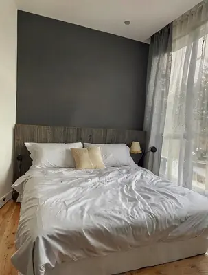 a bedroom with a white bed with a large window at Comfort Zone in Bangkok