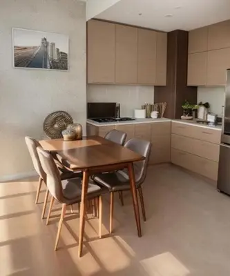 a kitchen with a wooden dining table and chairs at Comfort Zone in Bangkok