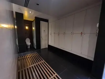 a room with a bench in a bathroom with a toilet at Comfort Zone in Bangkok