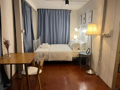 a small bedroom with a bed and a table at 3 bedrooms 2 bathroom's in Bang Su