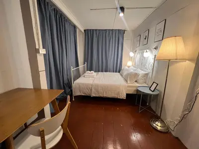 a small bedroom with a bed and a table at 3 bedrooms 2 bathroom's in Bang Su