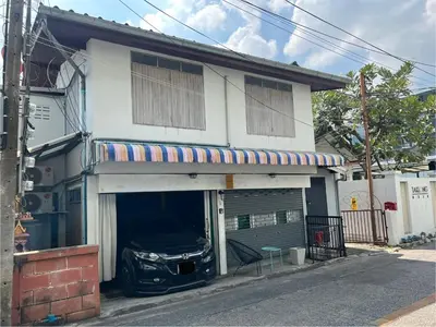 a car parked inside a garage in front of a house at 3 bedrooms 2 bathroom's in Bang Su