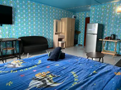 a bedroom with a bed with a blue blanket at impact เมืองทองธานี ห้องเช่ารายวัน pupular condo T9 C5 C4 C9 T8 in Thung Si Kan