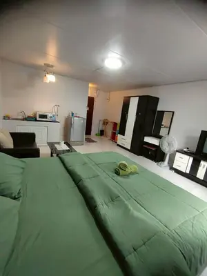 a living room with a large green bed in it at impact เมืองทองธานี ห้องเช่ารายวัน pupular condo T9 C5 C4 C9 T8 in Thung Si Kan