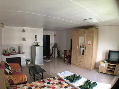 a living room with a couch and a tv at impact เมืองทองธานี ห้องเช่ารายวัน pupular condo T9 C5 C4 C9 T8 in Thung Si Kan